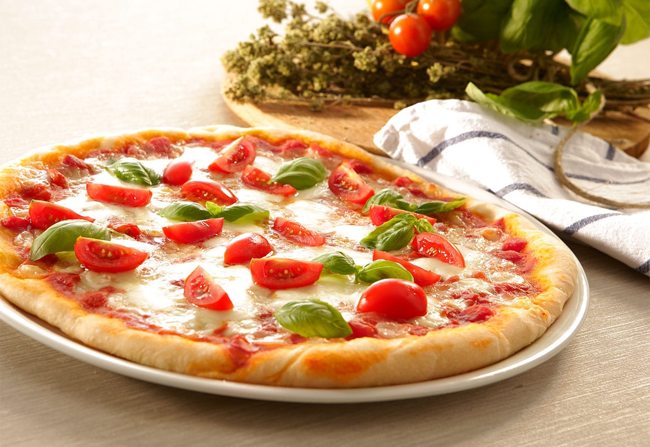 Melted cheese on fresh pizza